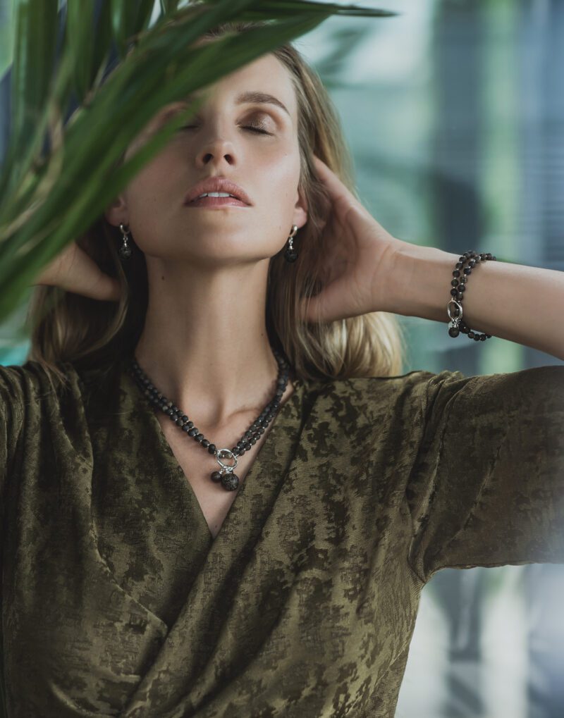 double necklace and bracelet with 5mm black baltic amber and sterling silver set pendant earrings and rings duo nero on model